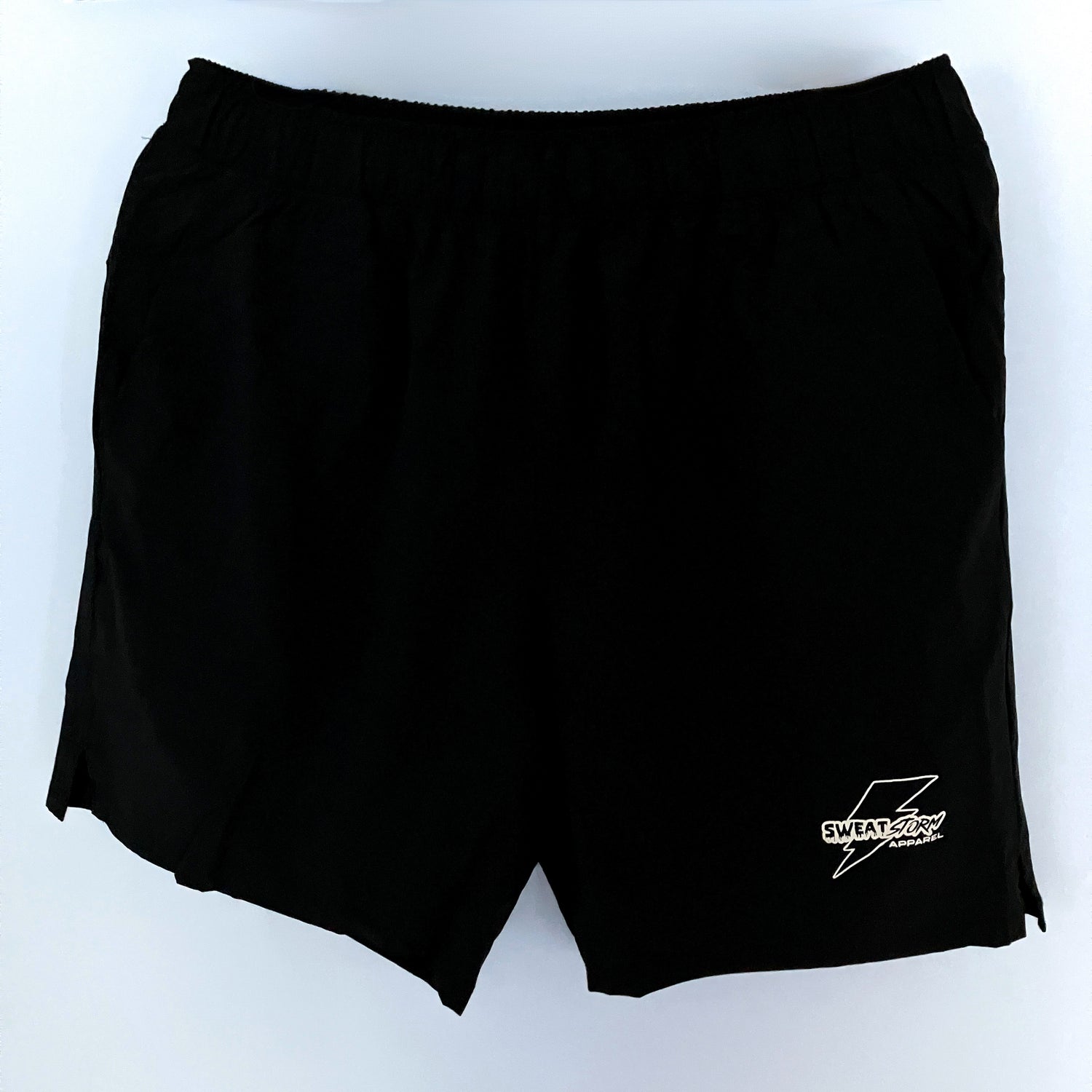 Black shorts with a white Sweat Storm Apparel logo on a white background