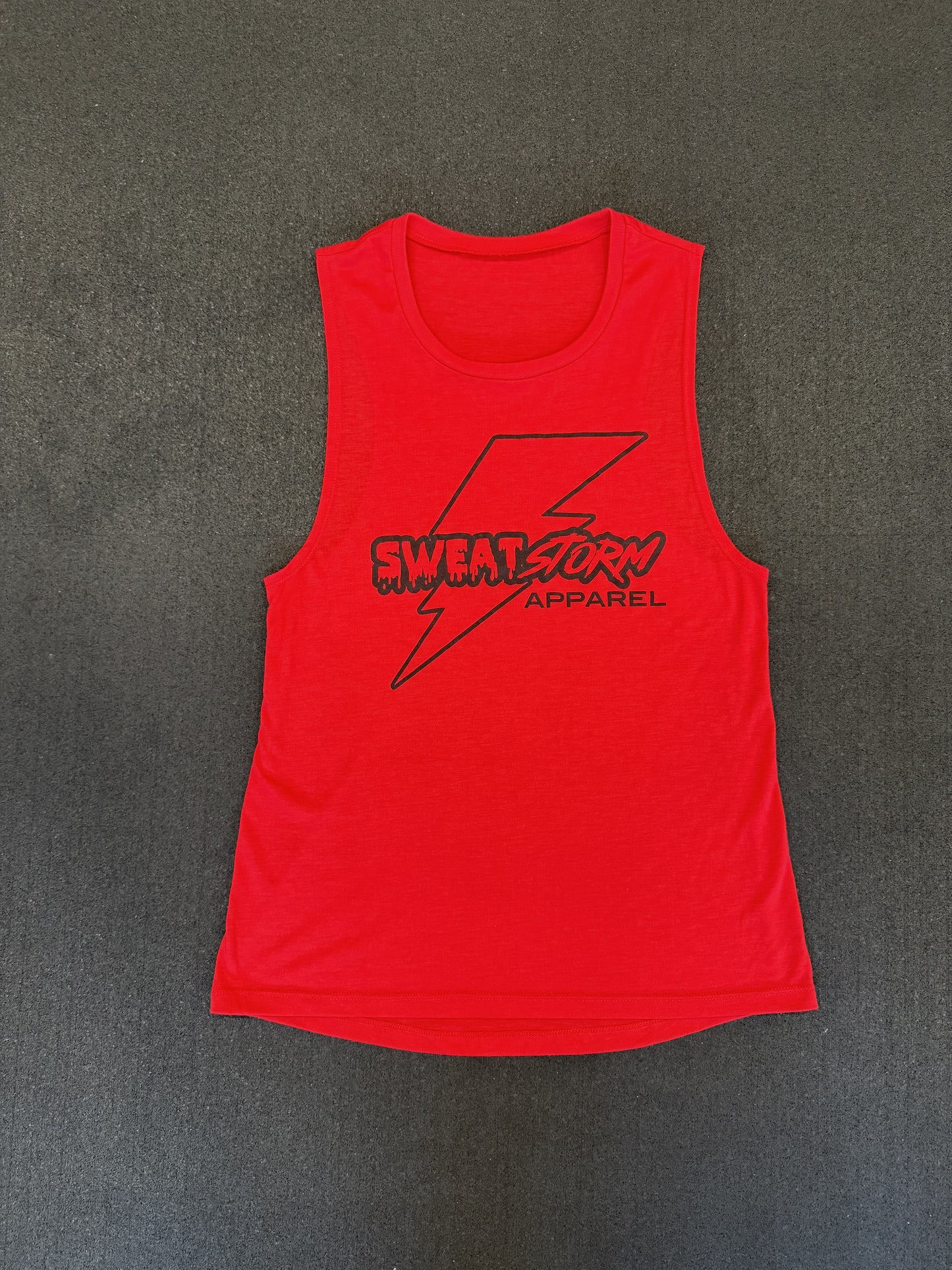 Red tank top with 'Sweat Storm Apparel' logo on a gray background