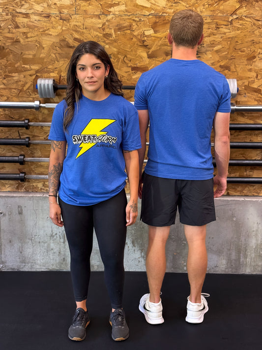 Two people wearing blue Sweat Storm Apparel logo t-shirts in a gym setting